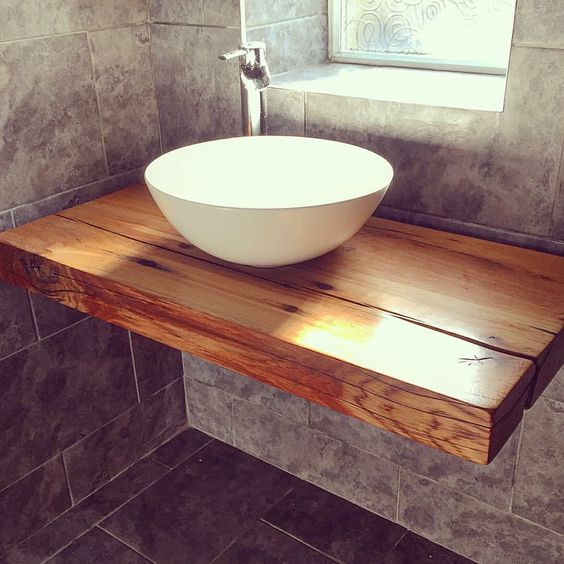 a floating bathroom shelf with a vessel bowl sink is a simple solution for a small bathroom