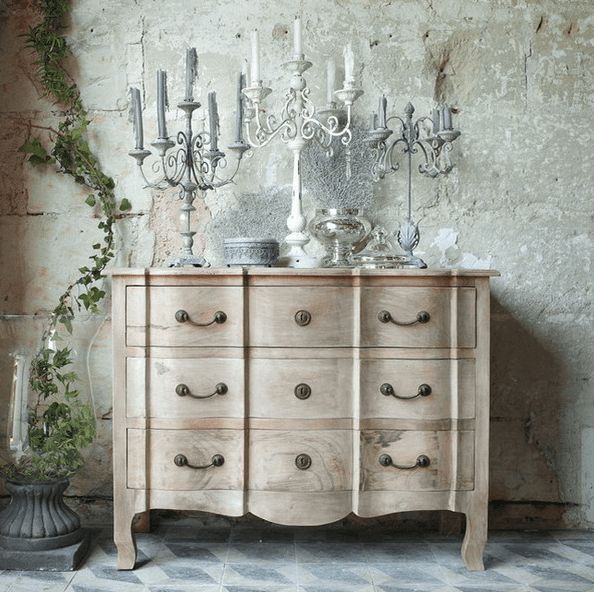 beautiful light-colored wood vintage dresser with antique candle holders