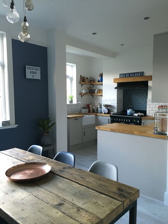 mid-century modern kitchen and dining space, warm wood surfaces to tie both