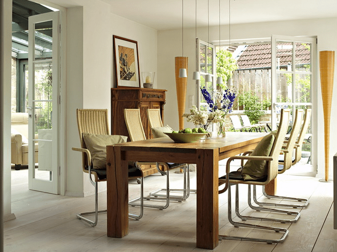 The dining room is decorated in a creamy color palette and warm earthy shades like green, brown and beige