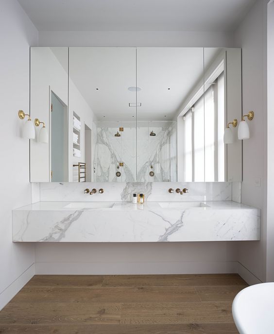 a floating marble vanity top gives a feeling of luxury to the space