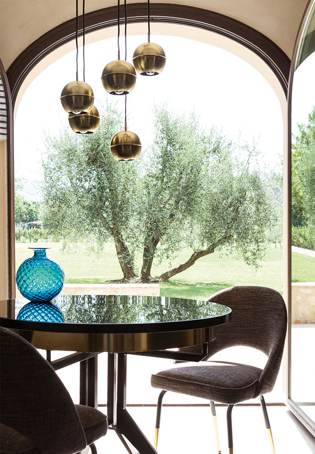 The dining space with adorable brass pendant lamps make up the look, and wonderful views all over too
