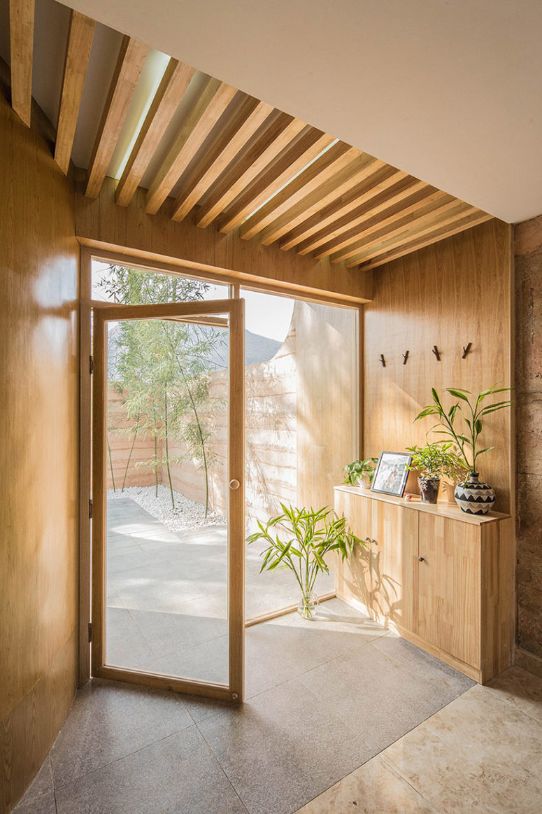 wood interiors The interiors are covered with light-colored wood and tiles to connect them to outdoors and make them cozy and inviting