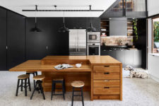 04 The kitchen is a modern sleek one, all the handles hidden and done in black, with a cool sculptural kitchen island