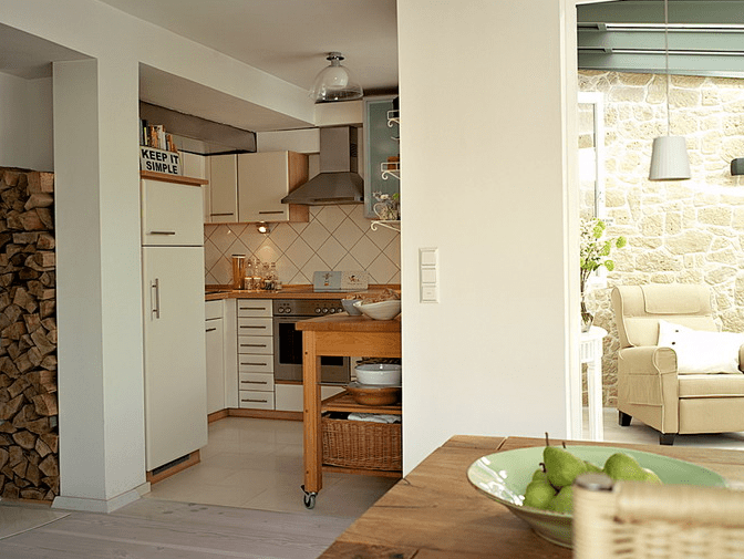 The kitchen is a small nook decorated in the same creamy shades and though it's small, there's everything necessary