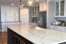 04 a statement kitchen island in dark wood with a white quartz counter can transform any kitchen