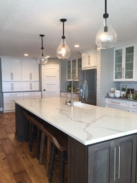 04-a-statement-kitchen-island-in-dark-wood-with-a-white-quartz-counter-can-transform-any-kitchen.jpg