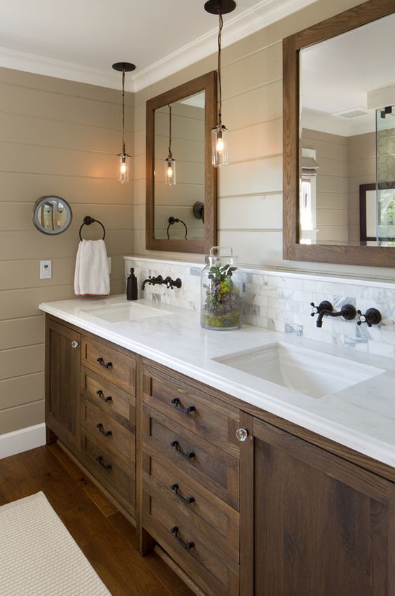 dark stained farmhouse bathroom cabinetry with a white counter