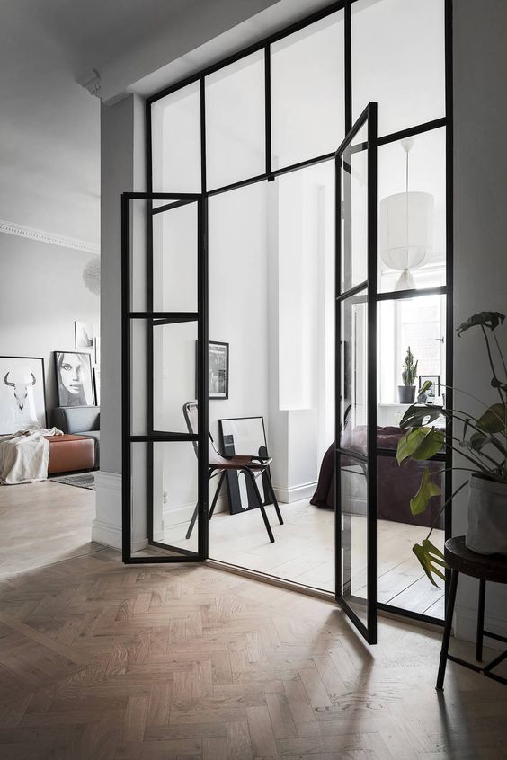 Scandinavian interiors with black framed French doors to fill the spaces with light