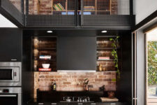 05 The brick backsplash creates a cool contrast with sleek black panels