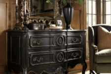 05 a dark wood sideboard with antique decor, a mirror and a dark vase