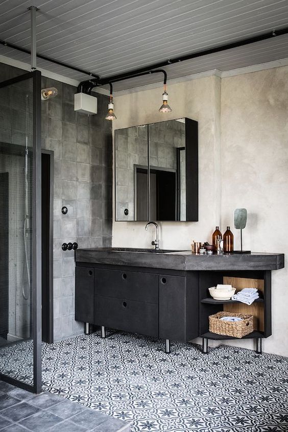 dark metal vanity with a concrete countertop