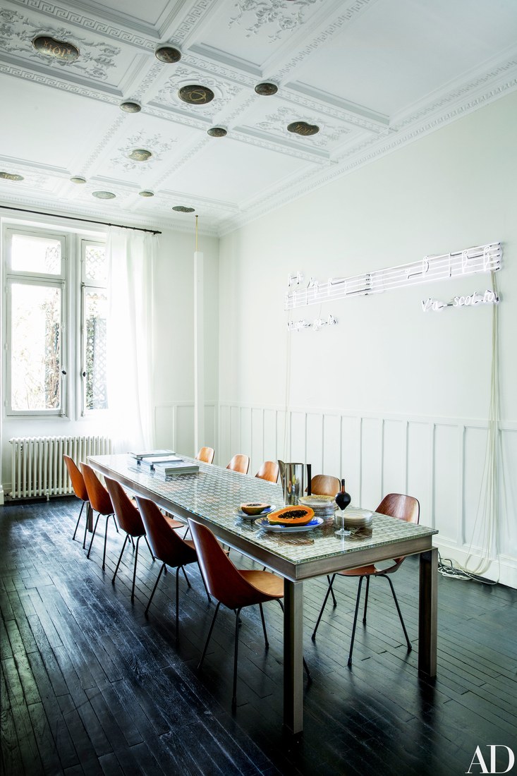 The dining room used for work also features the original plasterwork on the ceiling and a vintage dining table with a cool top