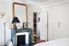 06 The focal point of the bedroom is the turquoise shabby chic fireplace with an oversized antique mirror over it