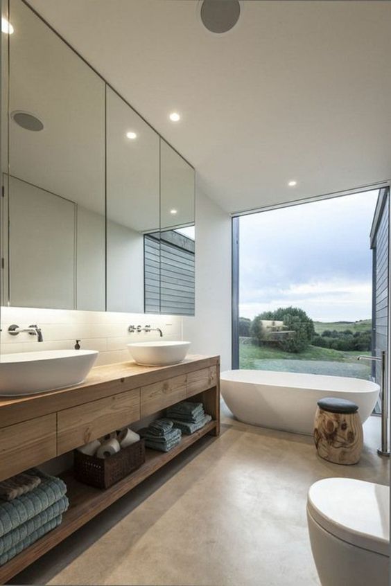 large wooden bathroom vanity with drawers and an open shelf