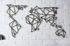 06 white brick wall with black graphic map of the world as a wall art