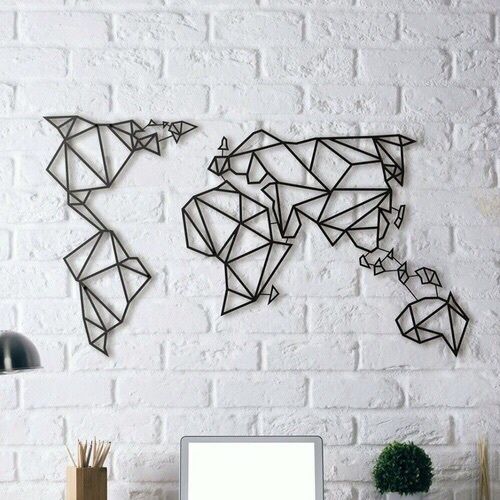 white brick wall with black graphic map of the world as a wall art