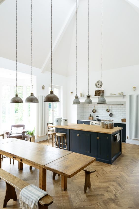 rustic and industrial kitchen decor with lot of warm woods and pendant lamps that unite the space