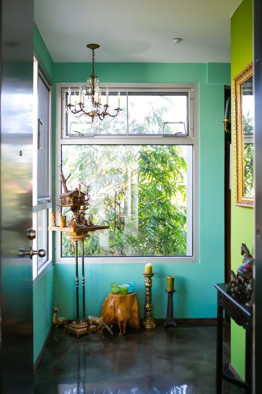 turquoise and lime green walls for a whimsy entryway with lots of accessories