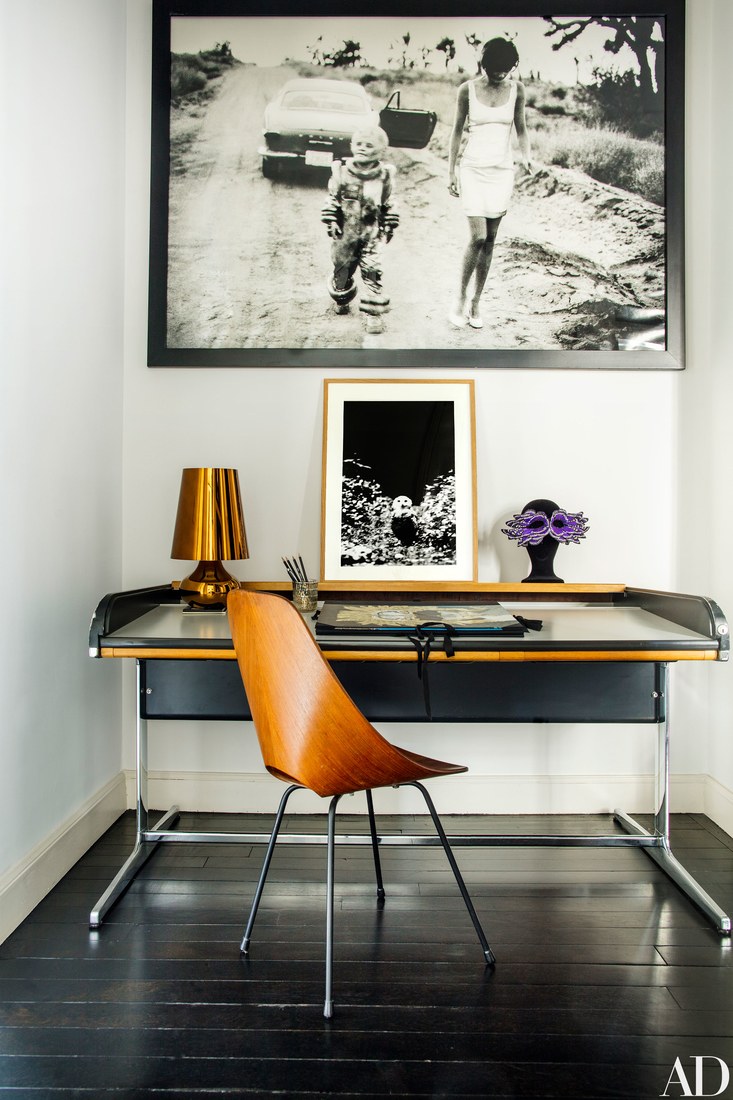 tiny home office Home office nook with a black desk and a bent wood chair, there are bold orange-ocher details that make it cozier