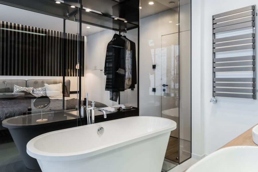 The bathroom is behind a glass partition, which is an interestig solution
