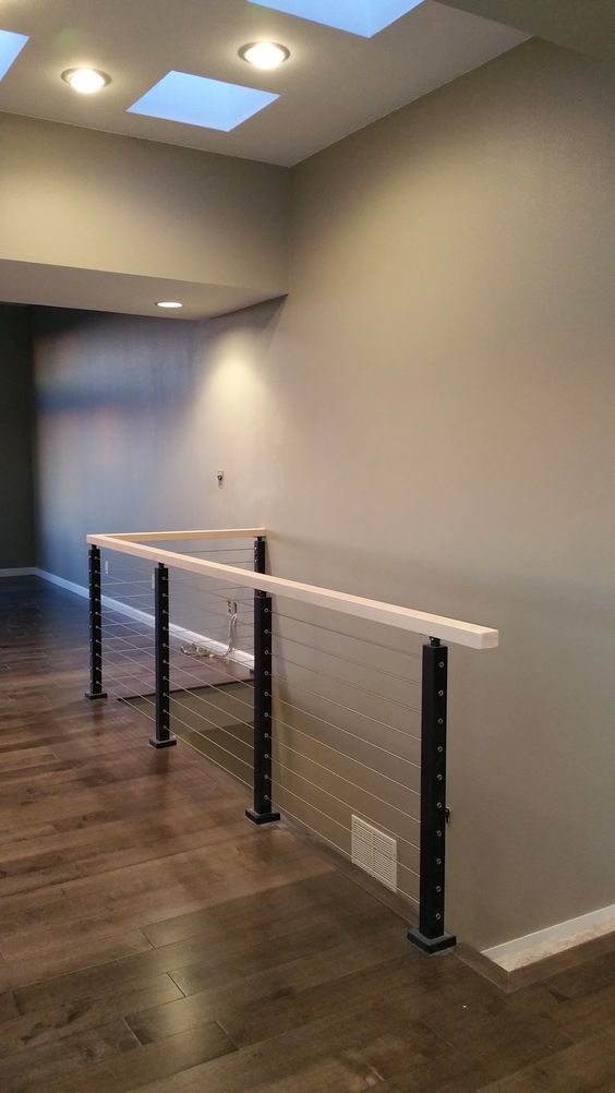 black steel posts, white wood and cable railing for a sleek modern look