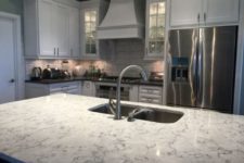 11 mmodern farmhouse kitchen in white with a white quartz counter on the kitchen island