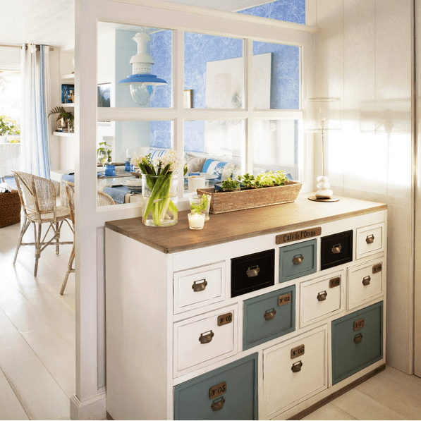 a vintage dresser with lots of drawers in different colors and shapes for entryway storage