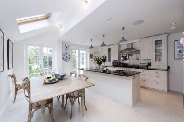 modern kitchen in black and white and a rustic dining space with vintage furniture