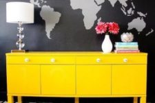 13 black and grey world map wall mural looks contrasting with a neon yellow sideboard