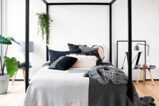 13 chic modern bedroom with a black frame bed and lots of greenery