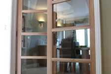 13 internal doors made from oak with glass paneling throughout; providing a simple yet elegant transition from living room to dining room