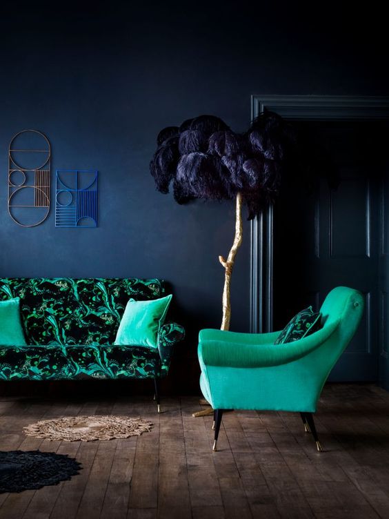 emerald upholstery and a navy wall for a moody yet bold living room