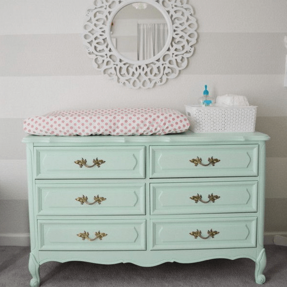 mint-colored dresser repurposed into a diaper changing table