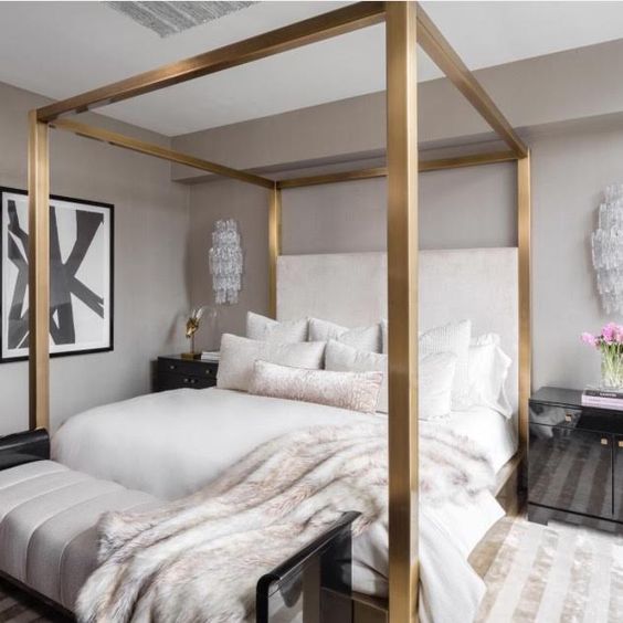 shiny brass frame canopy bed for a modern bedroom
