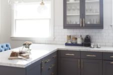 18 vintage dark grey cabinets with white quartz countertops and brass details
