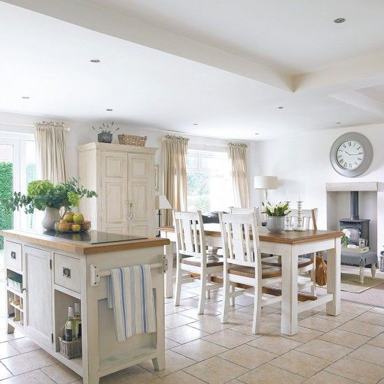 serene white kitchen with off-white furniture and a comfy diner by the hearth