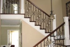 19 traditional stairs with a wooden handrail and a wrought iron balustrade with a chic pattern