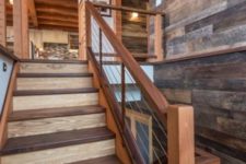 19 walnut stairs with stainless steel cable rails and wooden posts has a modern yet rustic look