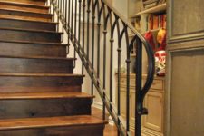 20 rustic stairs of wood with a wrought iron handrail and banister