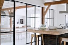 20 the kitchen and dining room divided with a framed glass wall with a door
