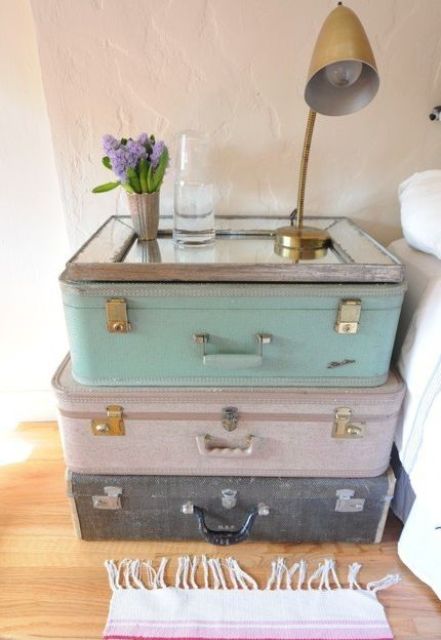 old suitcases stacked on each other and a mirror on top for a unique nightstand