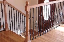 24 chic light-colored wooden staircase with dark wrought metal railing for a contrast