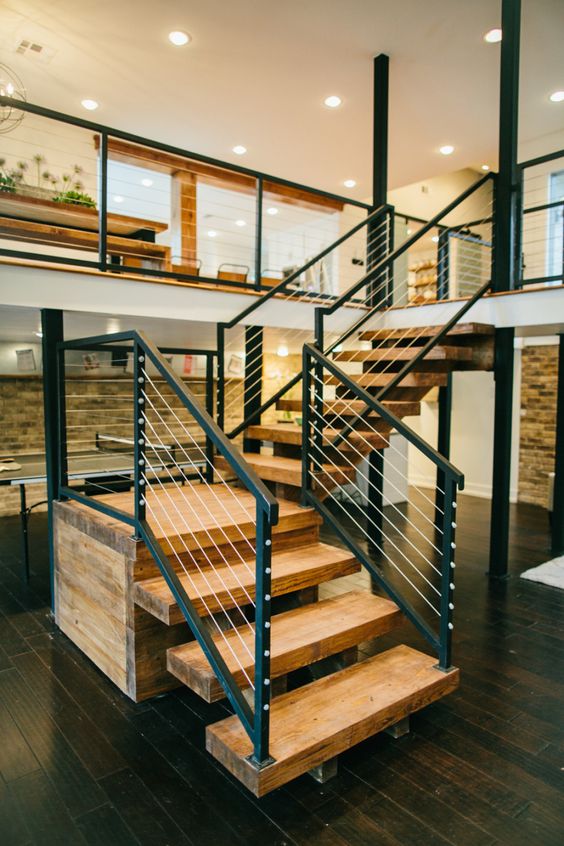 ultra-modern yet a bit rustic light-colored reclaimed wood staircase with dark metal and cable railing