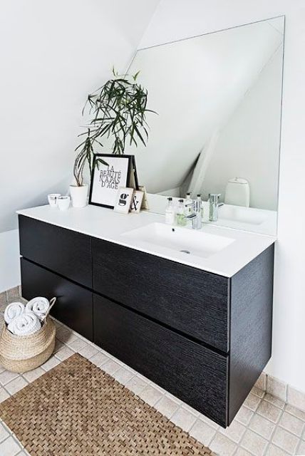large floating cabinet in a dark shade and a contrasting white surface with a sink