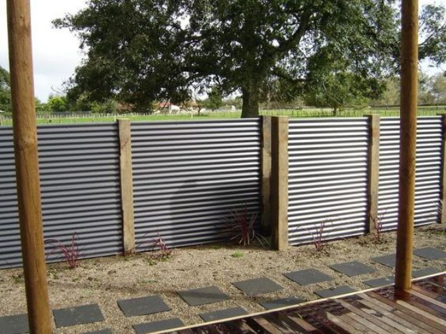 corrugated metal sheet fence with wooden posts