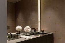 27 dark glam bathroom with a lit up mirror in a niche