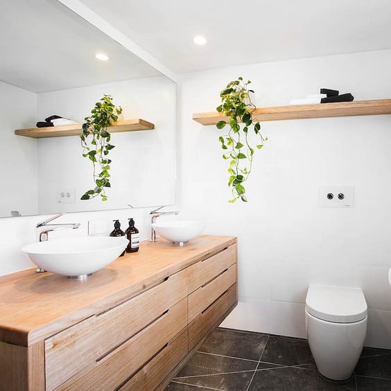 large wooden vanity with lots of drawers in a modern bathroom
