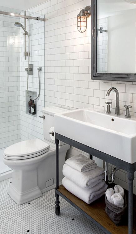 metal and wood bathroom vanity on casters looks vintage and industrial