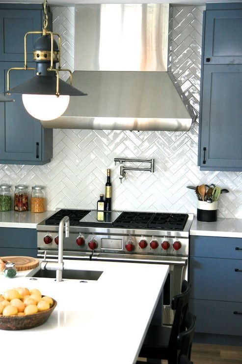 steel blue cabinetry, white quartz countertops, a white chevron backsplash